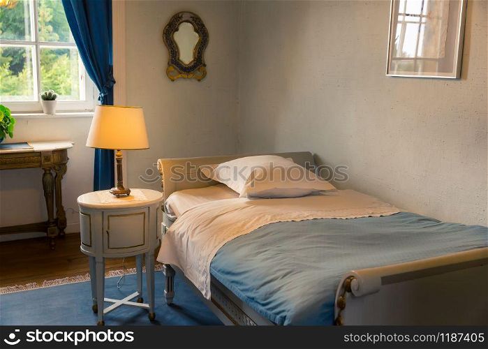 Room interior with vintage furniture in white tones, Europe. Ancient european architecture and style, famous places for travel and tourism. Room interior, white vintage furniture, Europe