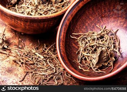 Roots and rhizomes Valerian officinalis. Traditional remedy from valerian roots in a mortar.Herbal medicine
