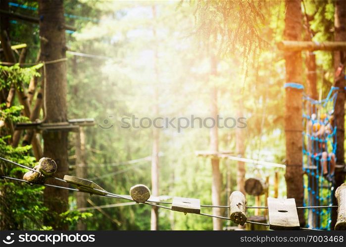 rope bridge in climbing forest or high wire park and nature background