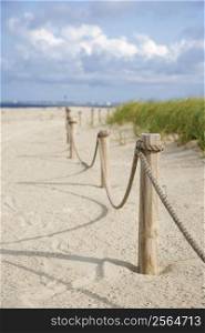 Rope fence barrier on beach.