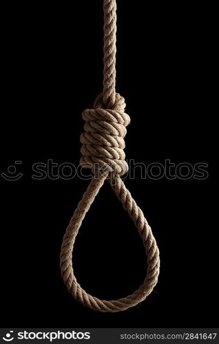 Rope noose with hangman&acute;s knot hanging in front of black background.