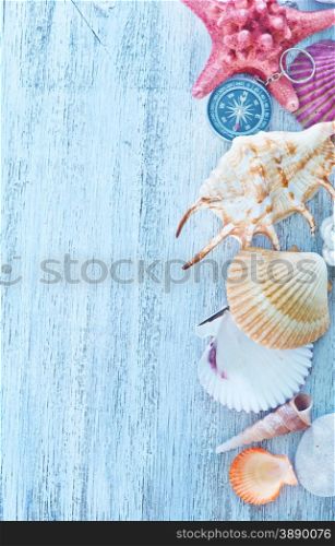 rope,sea shell and compass on a table