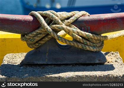 Rope tied to cleat on fishing pier.