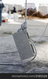 Rope tightened on a concrete block