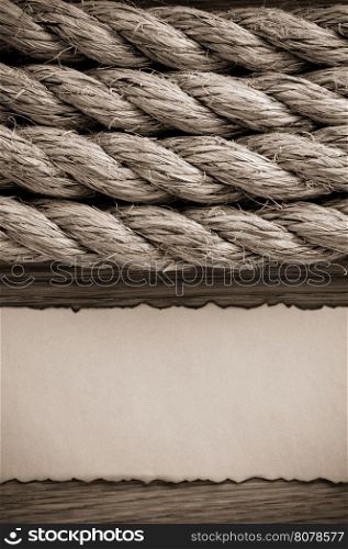 ropes and old paper at wooden background