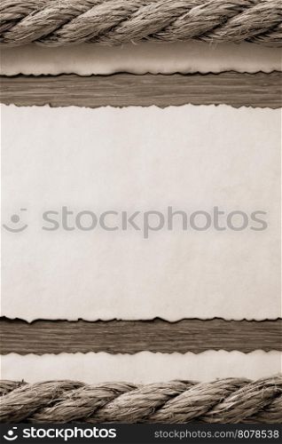 ropes and old vintage ancient paper at wooden background