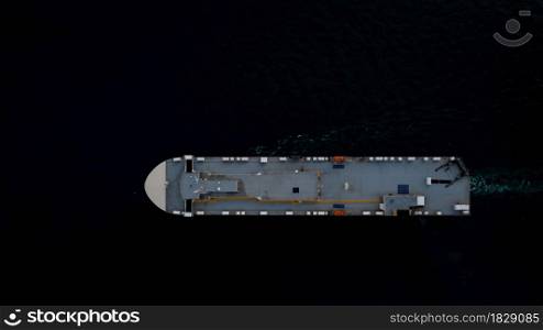 roro ship sailing in the dark sea aerial top view transportation international concept
