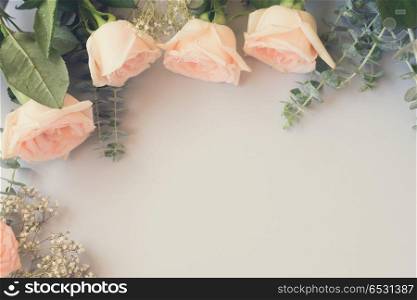 Rose flowers on blue table from above with copy space, retro toned. fresh rose flowers. fresh rose flowers
