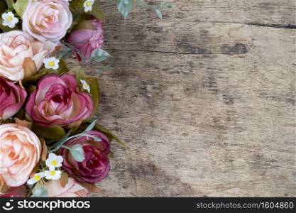 Rose flowers on rustic wooden background Copy space
