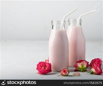 Rose moon milk for a better sleep. Ayurveda warm drink consumed before bed. Nice in case of sleeplessness, anxiety and insomnia. Moon milk prepares with pink rose flower in two bottles. Trendy relaxing bedtime drink form Ayurvedic traditions