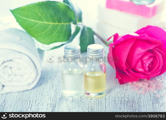 rose oil in bottle and on a table