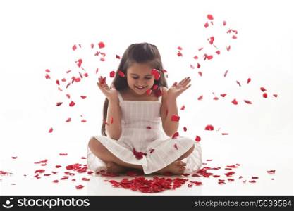 Rose petals falling on a little girl