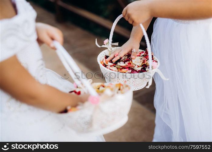 rose petals for the ceremony in wedding baskets in the hands of children