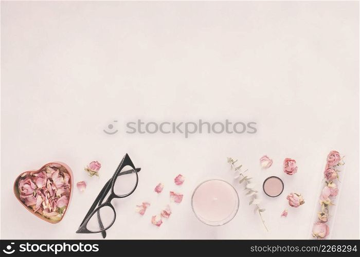 rose petals with glasses candle table