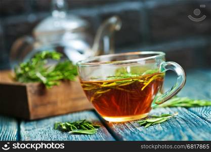 rosemary tea in cup and on a table