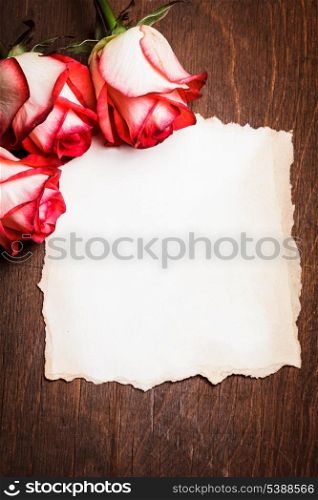 Roses and blank ragged card on the table