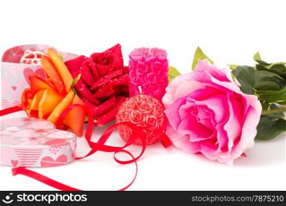 Roses, candles, red ribbon and gift box isolated on white background.