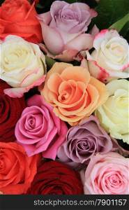 Roses in various bright colors in a mixed bridak bouquet