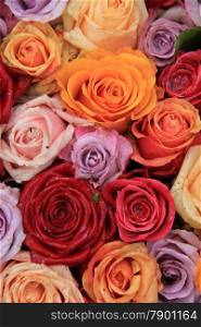 Roses in various bright colors in a mixed bridak bouquet
