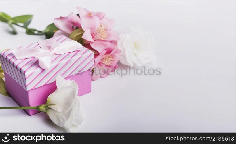 roses pink lily flowers with gift box white background