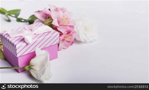 roses pink lily flowers with gift box white background