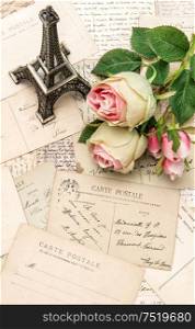 Roses, vintage postcards and souvenir Eiffel Tower from Paris.