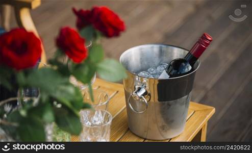 roses wine bottle ice bucket table