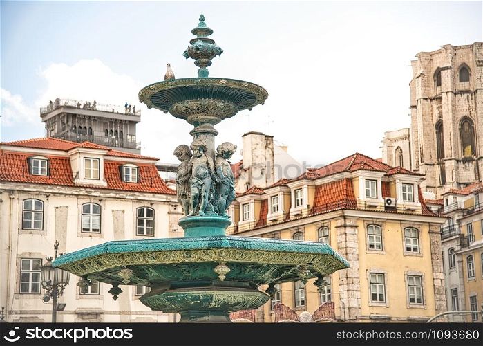 Rossio Square with fountain and sculpture, Lisbon.