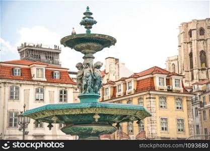 Rossio Square with fountain and sculpture, Lisbon.