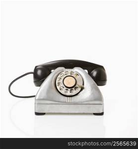 Rotary telephone with black receiver.