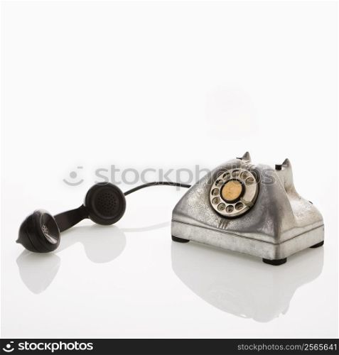 Rotary telephone with reciever to the side.