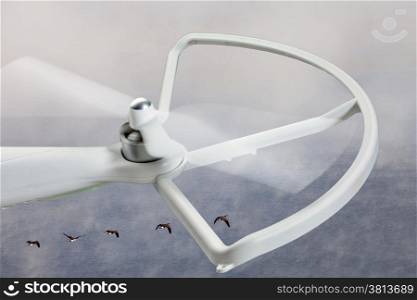 rotating propeller of a white quadcopter drone against foggy lake background