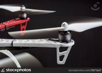 rotating propellers of a hexacopter drone against black background