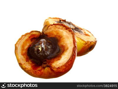 Rotten apple halves on white background. Food waste.