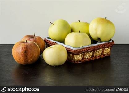 Rotten apples on a table with ripe apples. Fruit storage.. Rotten apples on a table with ripe apples.
