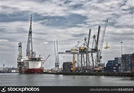 ROTTERDAM,HOLLAND,04-07-2014:big cranes for transport of containers in dutch harbor in Rotterdam, rotterdam is one of the biggest harbors in europe. big cranes in dutch harbor