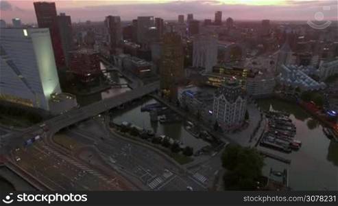 ROTTERDAM, NETHERLANDS - AUGUST 07, 2016: City aerial view in the evening. Urban scene with famous Cube Houses, White House, Markthal and road traffic