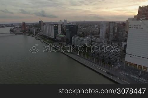ROTTERDAM, NETHERLANDS - AUGUST 7, 2016: Aerial view of cityscape with modern buildings, skyscrapers, office center on the river against cloudy sky