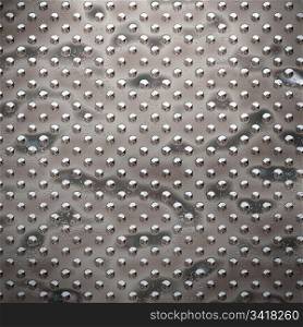 rough dots. a large image of rough and damaged studded metal
