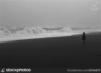 Rough sea and tourist monochrome landscape photo. Beautiful nature scenery photography with sky on background. Idyllic scene. High quality picture for wallpaper, travel blog, magazine, article. Rough sea and tourist monochrome landscape photo