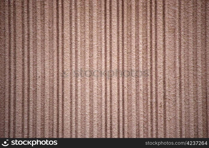 Rough textured concrete wall in brown hues