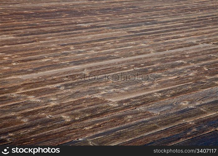 rough weathered wooden deck with diagonal plank pattern