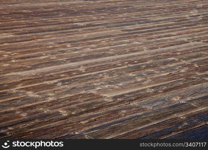 rough weathered wooden deck with diagonal plank pattern