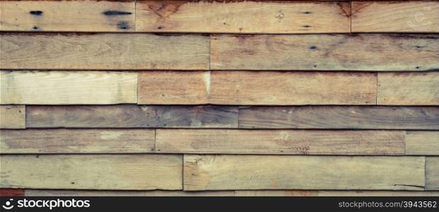 Rough wooden wall with the hammered nails background. Vintage filter effect image