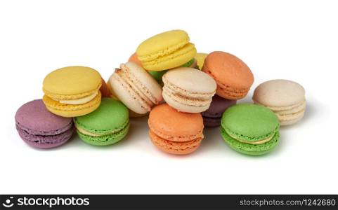 round baked multi-colored almond flour cakes macarons, dessert is laid out in a stack and isolated on a white background
