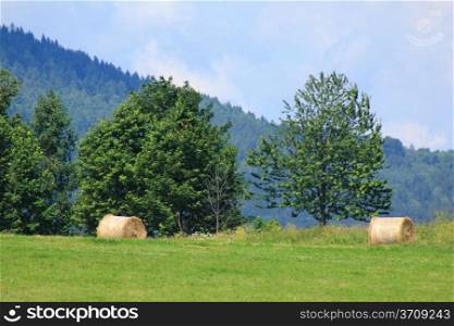 Round bales of hay at mountain landscape in Poland
