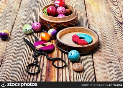 round beads for needlework. set of stylish beads for making jewelry on wooden background