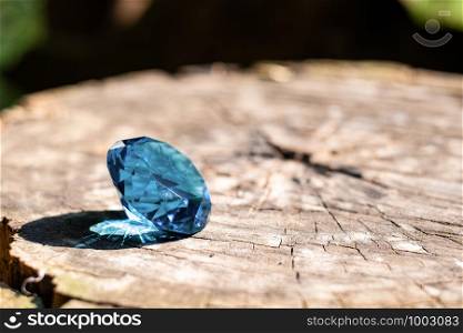 Round blue diamond at wood background