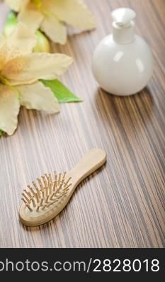 round bottle and hairbrush with flower