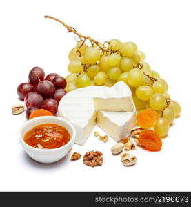 Round brie or camambert cheese and grapes isolated on a white background. Round brie or camambert cheese and grapes on a white background